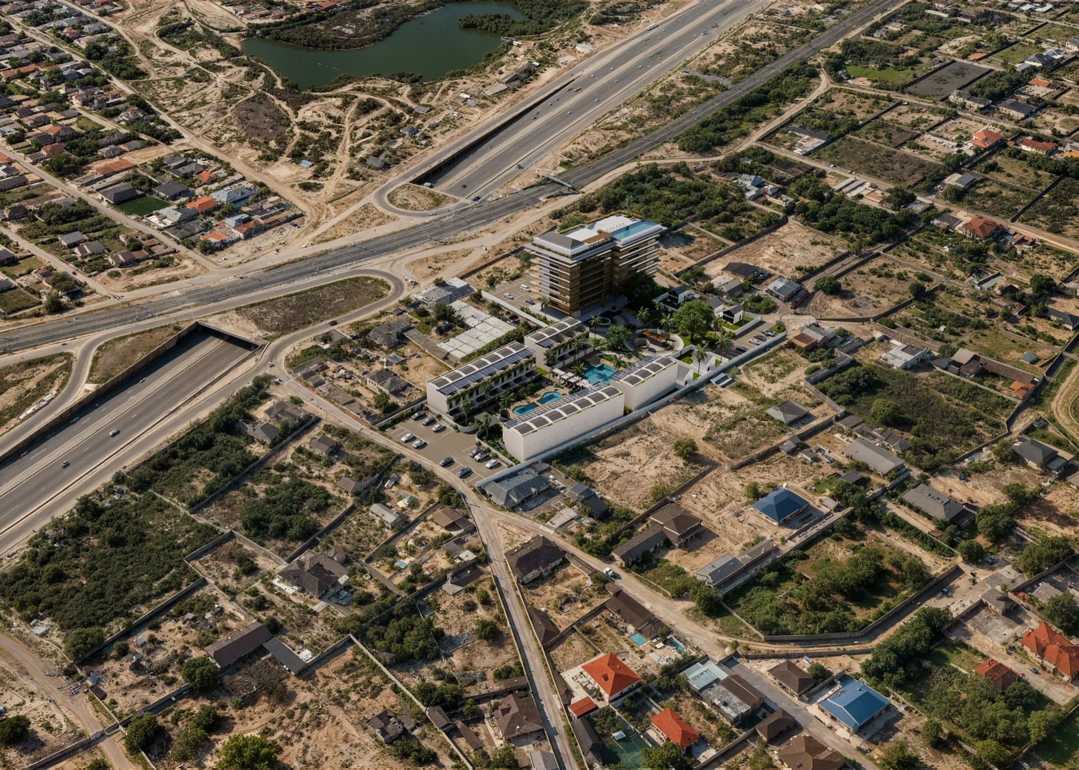 Aerial view of the site with the tower and garden homes beside the coastal highway interchange