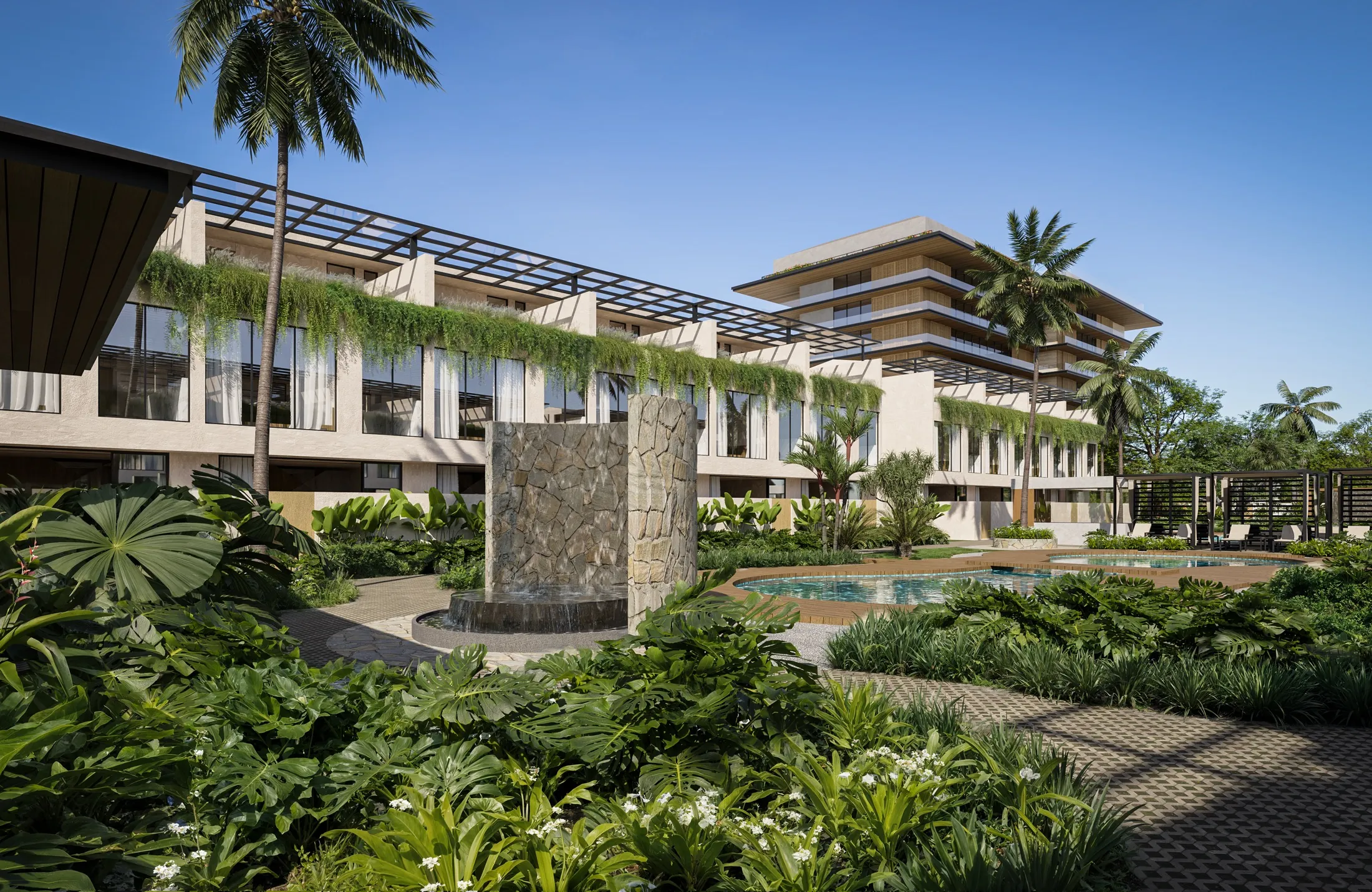 Stone water wall and planting in front of the garden homes, tower behind