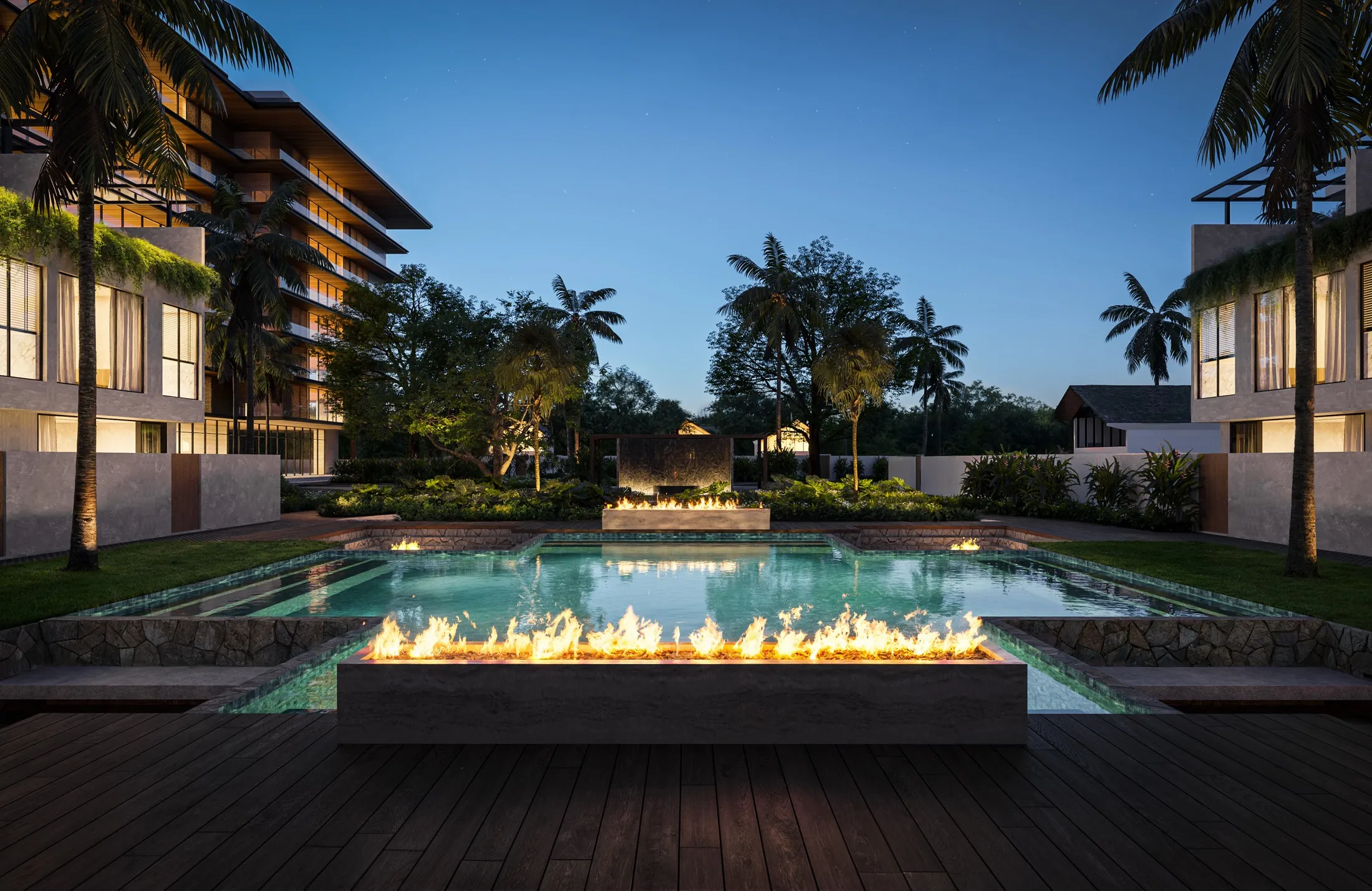 A long fire trough burning at the end of the pool at dusk, garden homes either side
